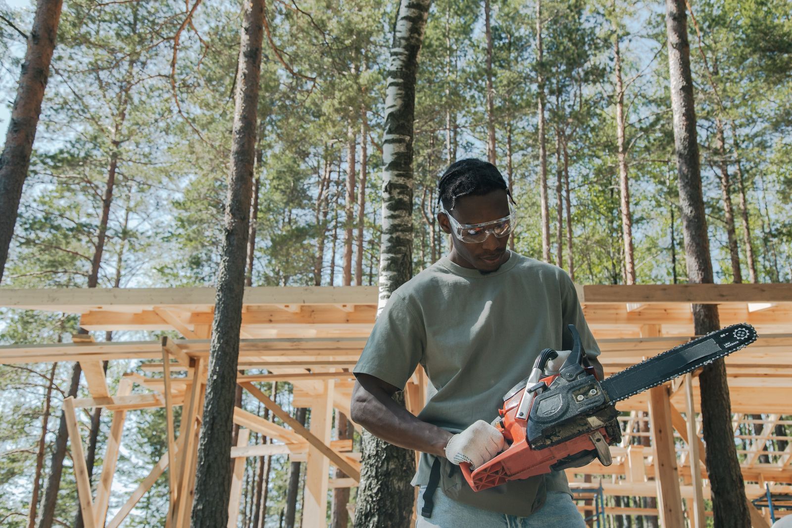 Member of the Sable team with a chainsaw on site