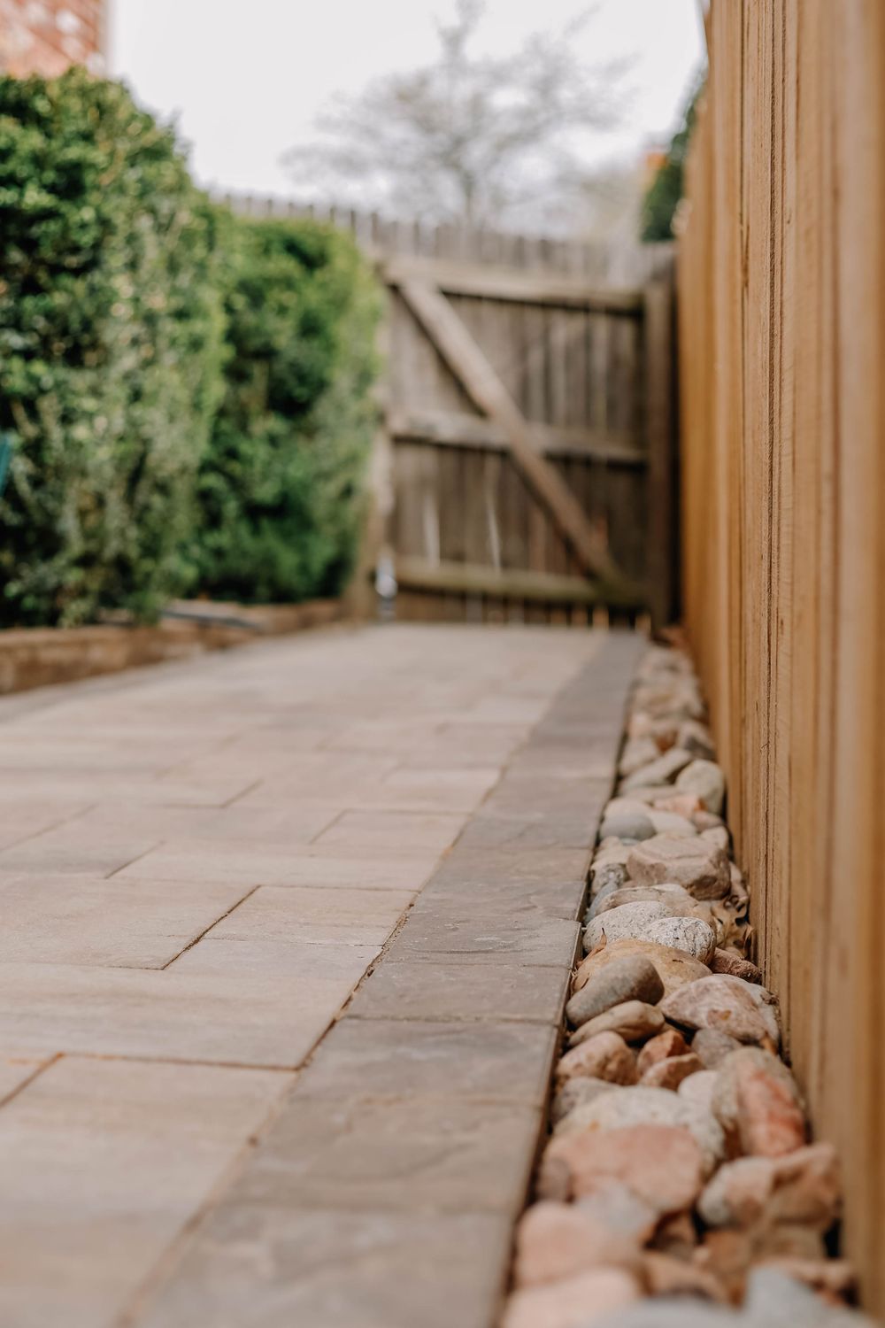 Paved side path beside a timber fence