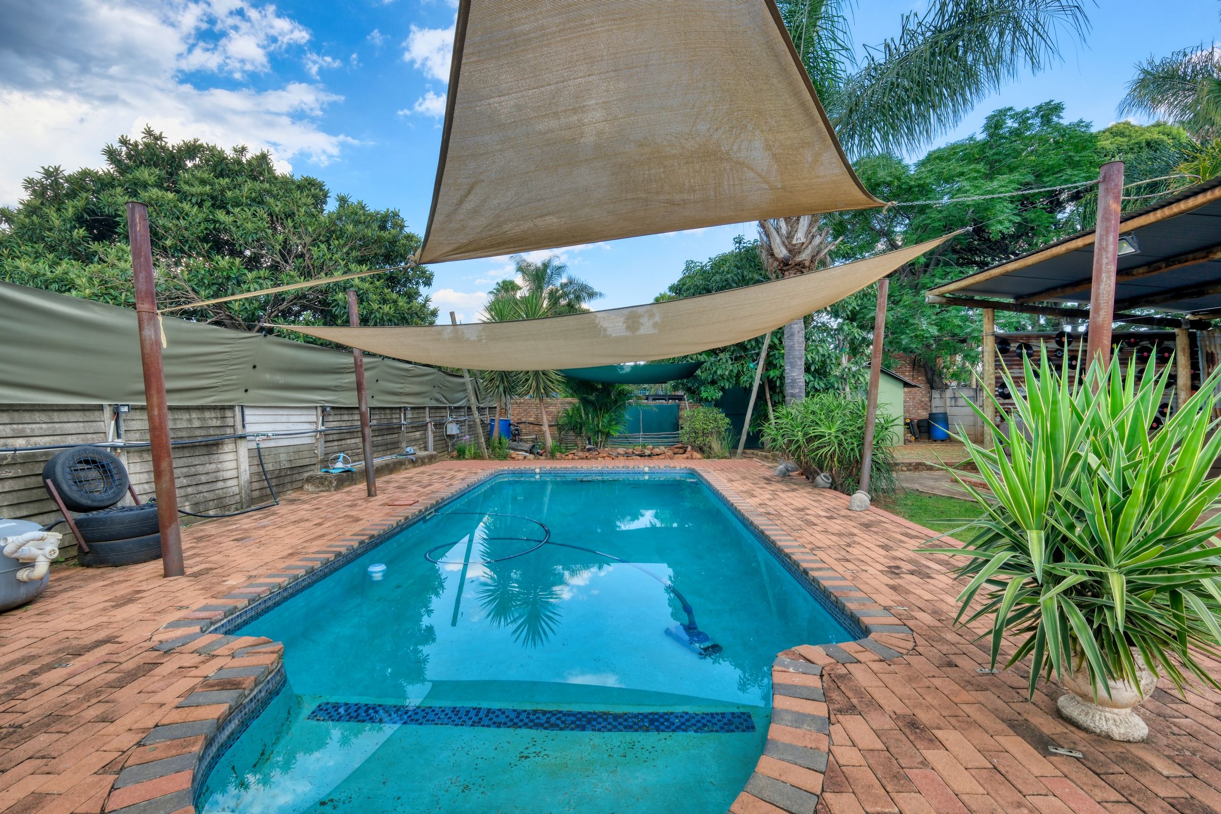 Brick paved pool area and patio in a Pretoria garden