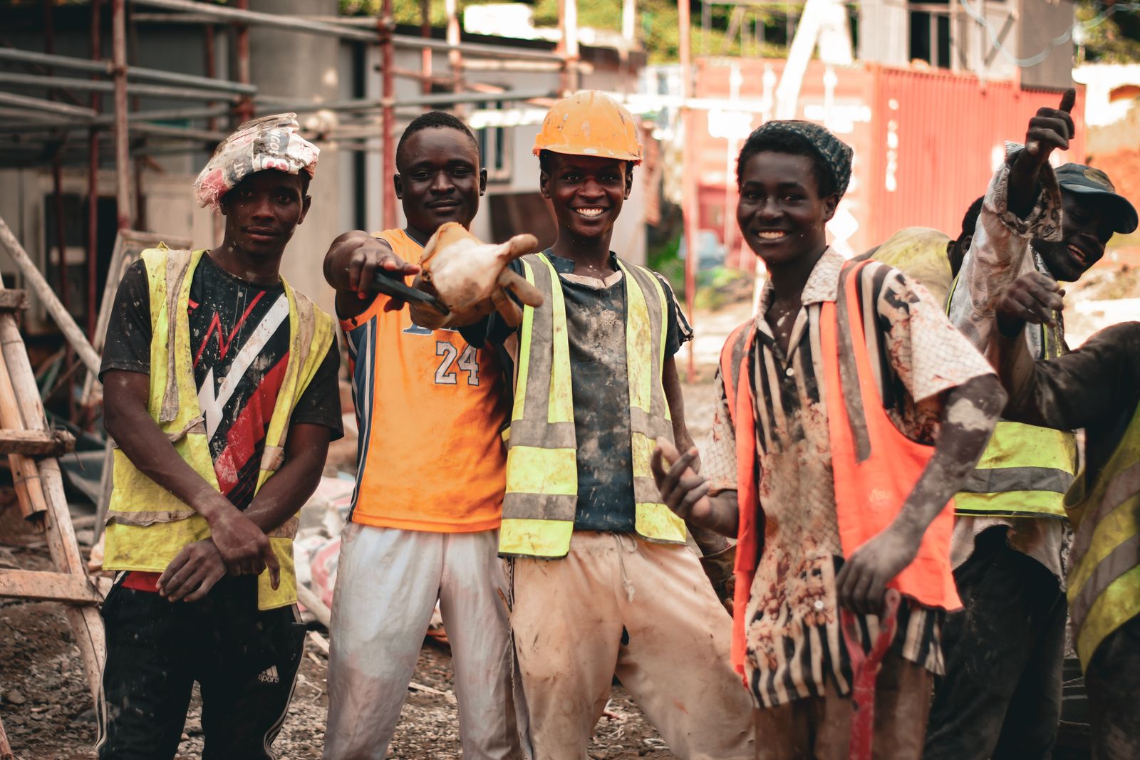 Smiling site crew in hi-vis vests on a building site
