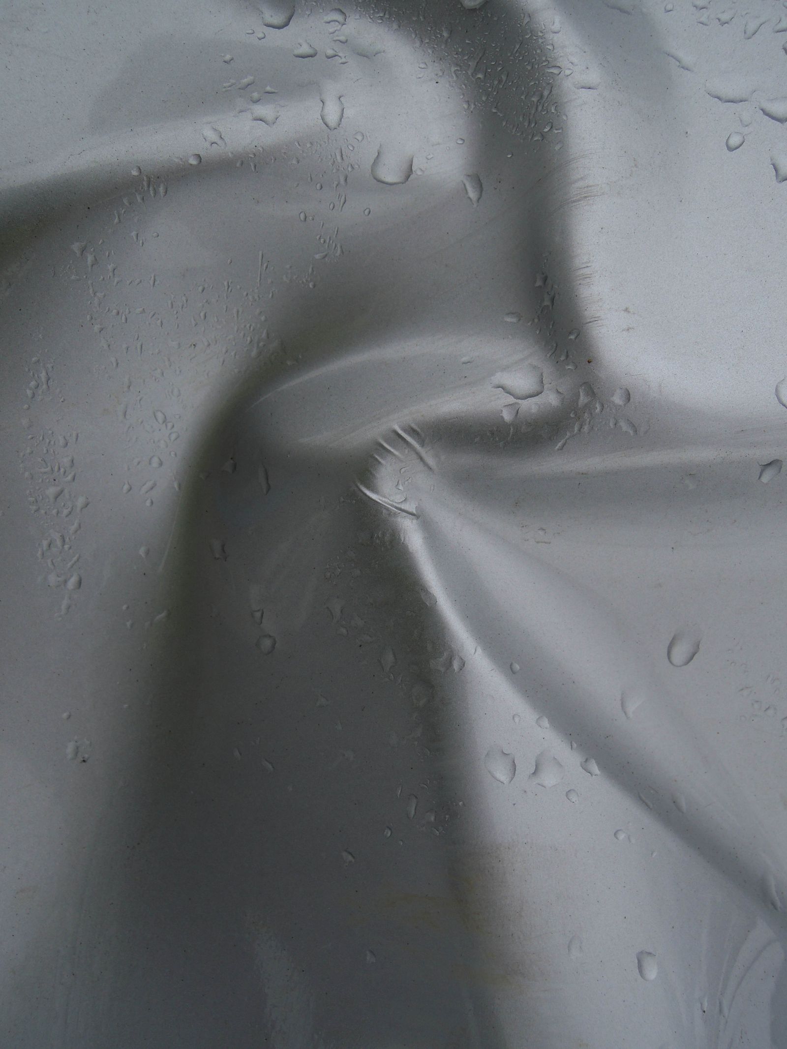 Raindrops beading on a waterproof membrane